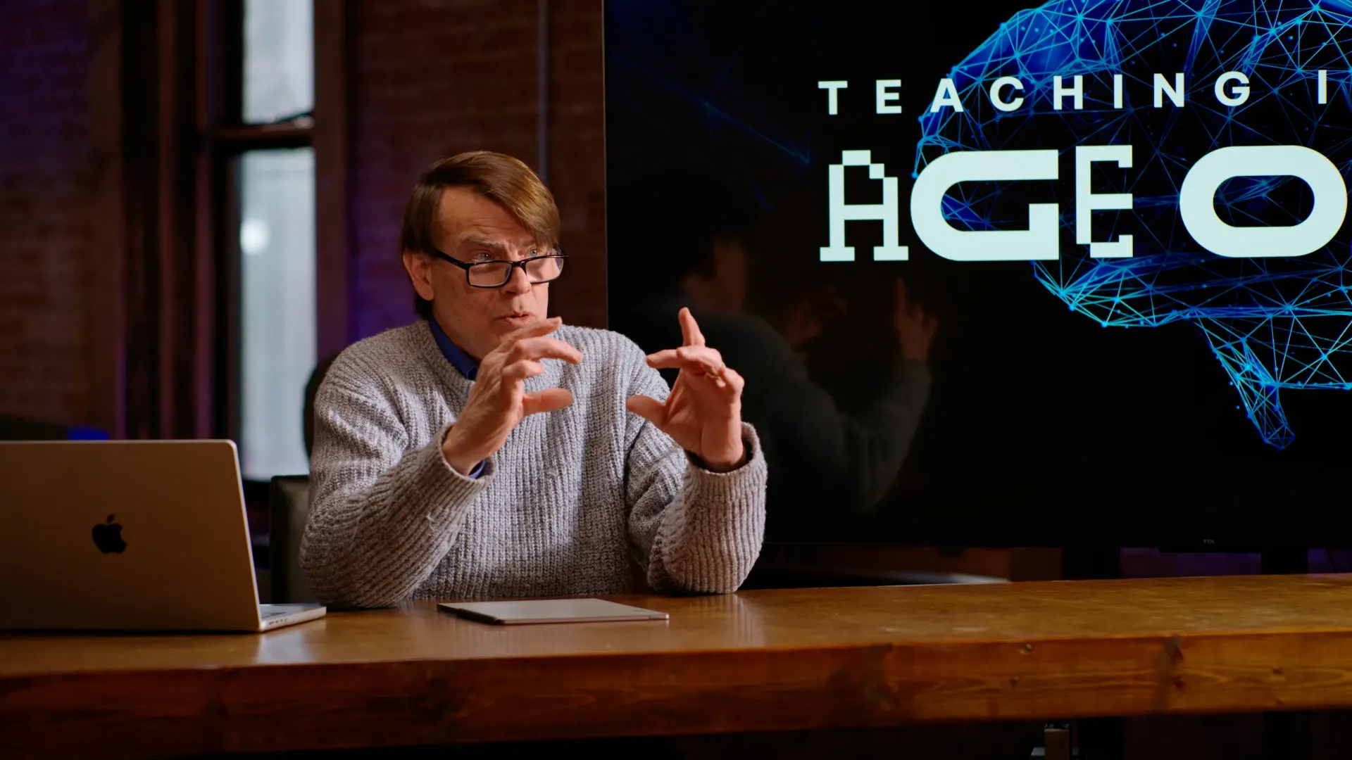 A professor gesturing as he explains an idea to camera during a Campus course shoot